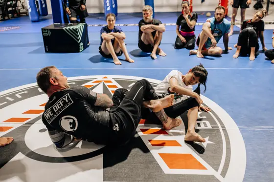 Coach demonstrating a technique on the Verde Valley logo